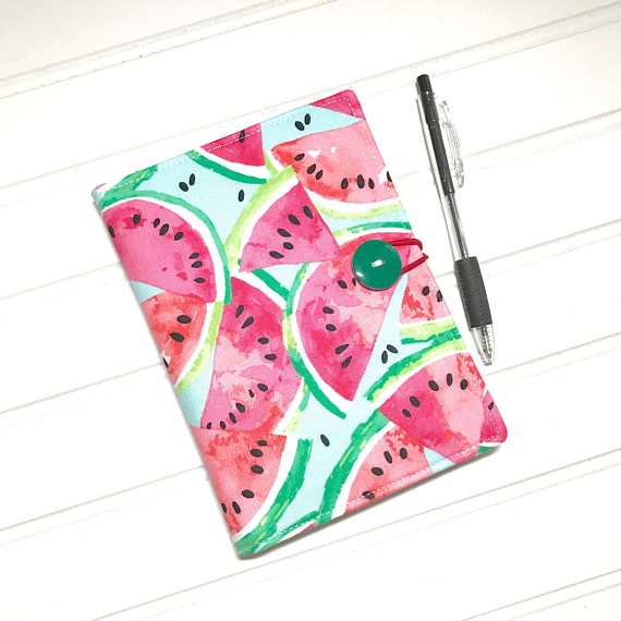 Watermelon patterned note and recipe holder with a pen beside it. 