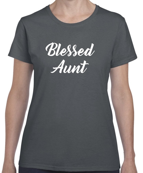 Women's body wearing a black t-shirt with white font that says Blessed aunt. 