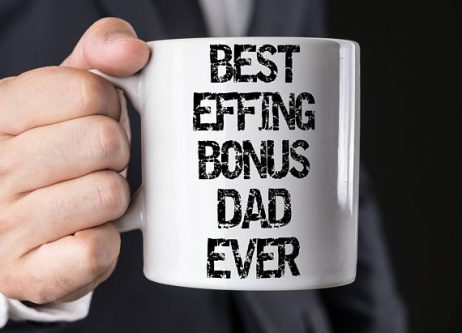 Father’s Day Gifts for my Stepdad - Close up of hand holfing a white coffee mug with black font that says best effing bonus dad ever. 