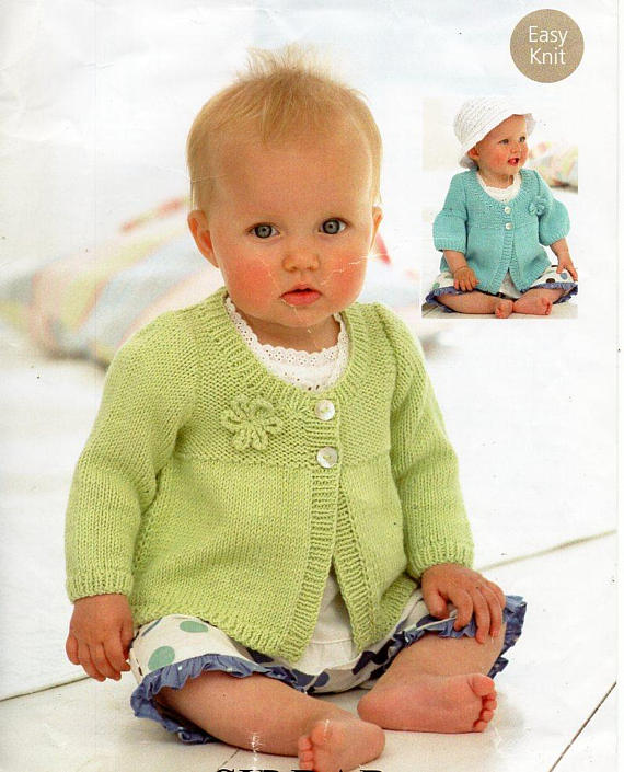Knitting pattern magazine with a baby on the cover wearing a lime green knitted sweater and the same baby in the background with a light blue knitted sweater. 
