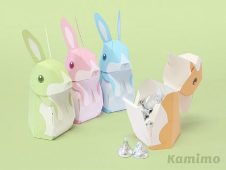 Four bunny gift boxes shown, one green, pink, and blue. Tan bunny opened showing it's filled with silver heresy kisses. 