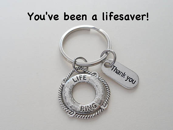 Silver keychain with a life ring on it and another charm that says thank you. 