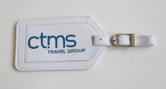 Company luggage tag, white luggage tag with blue font of CTMS travel group company. 
