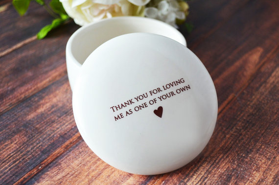 White round keep sake box with black font that says Thank you for loving me as one of your own with a little black heart below. 