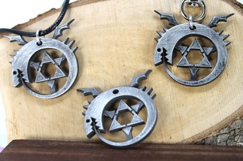 Three silver full metal alchemist ouroboros keychaines. 