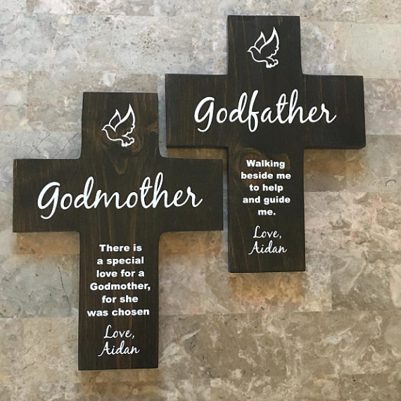Two wooden crosses with white font that says godmother and a poem below. 