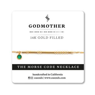Gold chain with Morse code stones on it and a green birthstone charm hanging on it 