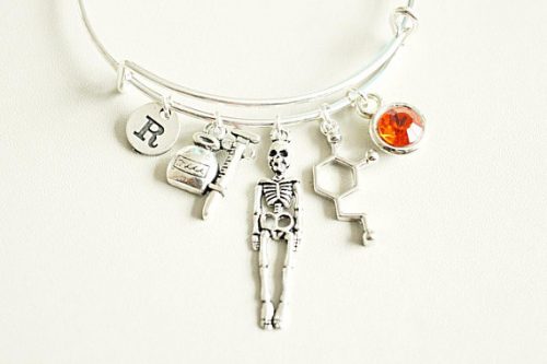 Silver biology bracelet with different anatomy charms. 