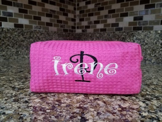 Mother's Day Gifts For 80 Year Olds: Pink waffle cosmetic bag with the name IRENE in white font stitched on it. 