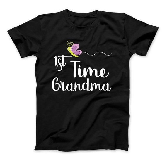 Mother's Day Gifts For First Time Grandmothers - Black t-shirt with white font that says 1st time grandma, with a green ad purple cartoon butterfly on it. 