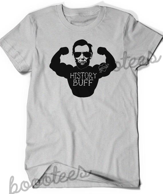 White t-shirt with black of a buff Abraham Lincoln.
