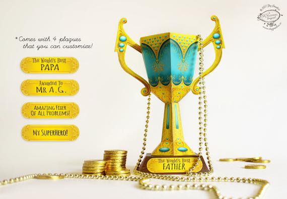 Papercraft yellow and teal colored trophy cup. 
