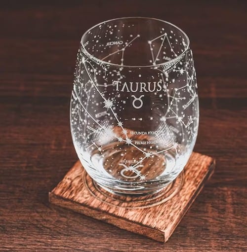 Stemless clear wine glass etched with Taurus name and symbol with constellations all over it.