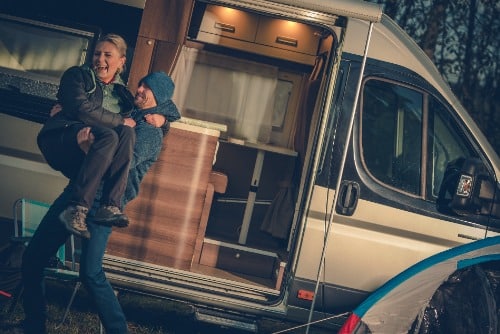 couple in front of an RV
