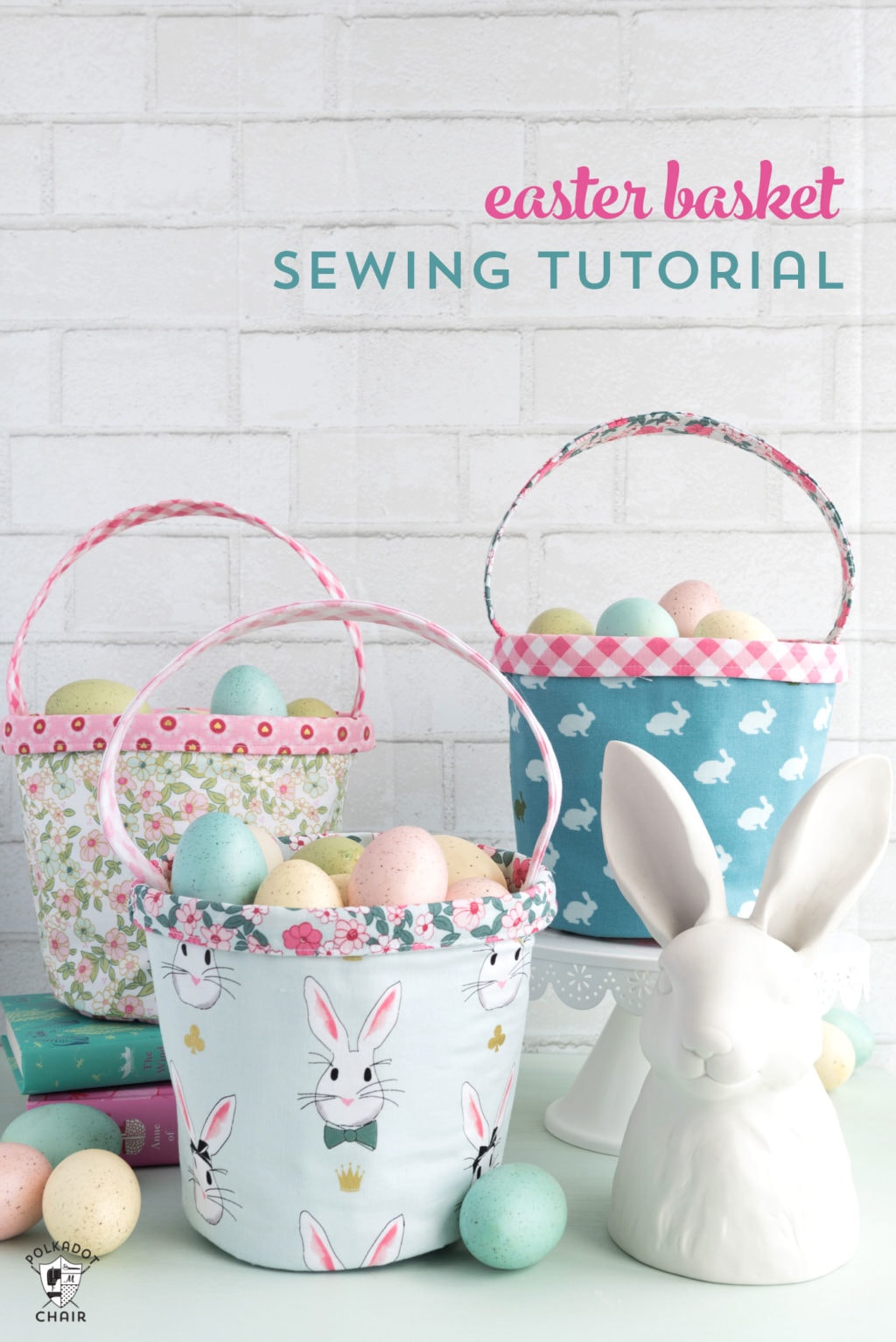 Three sewn Easter baskets, one with a flower pattern, one with bunny pattern faces, and lastly one that's blue with white bunny pattern. all beside a large white decorative bunny. 