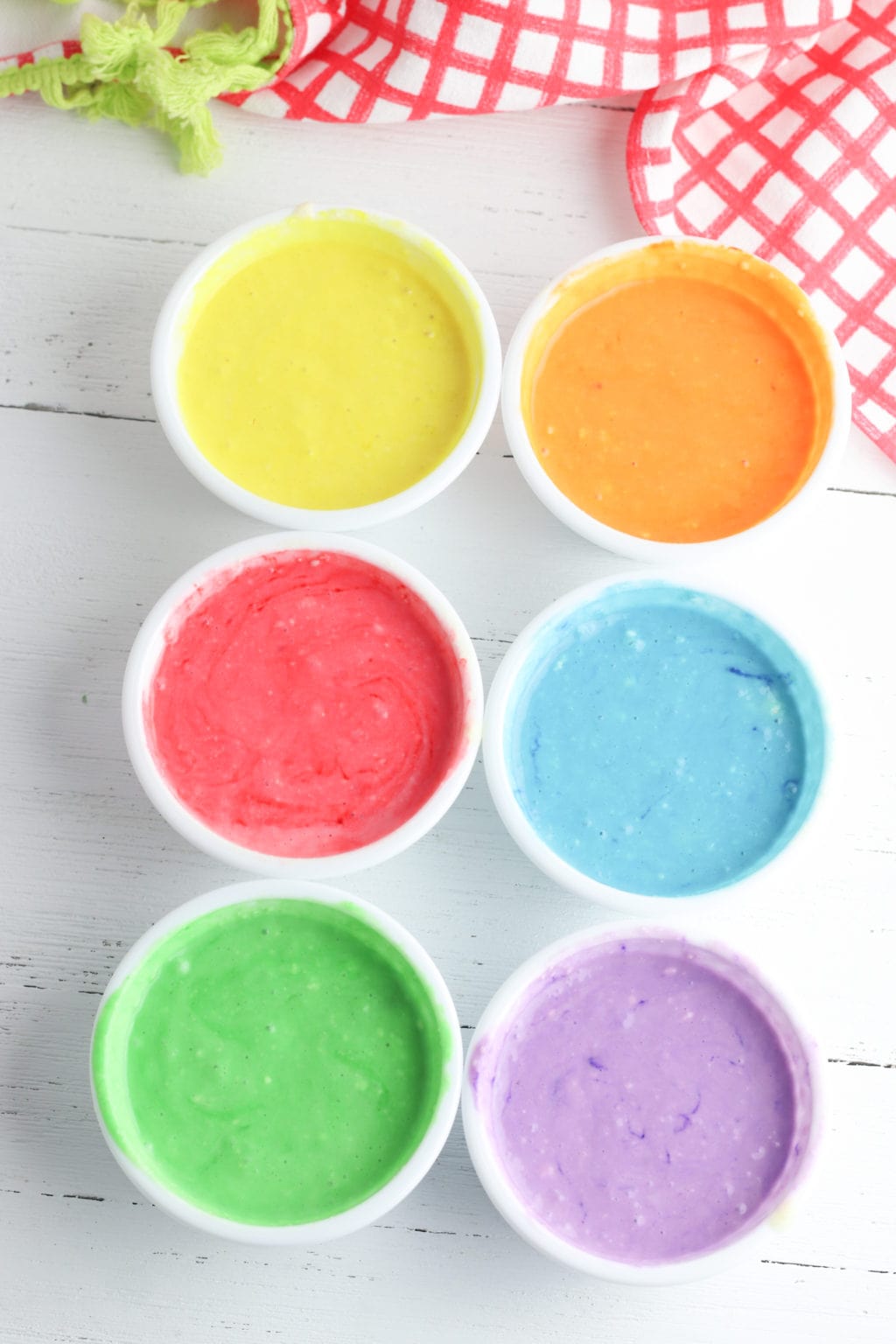 Colored bowls of pancake mix to make rainbow colored pancakes