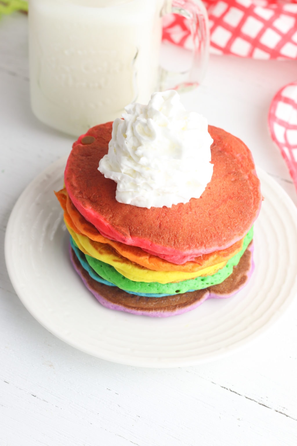 Rainbow panckaes with whipped cream on top
