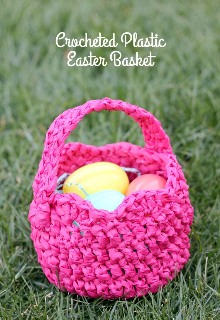 Pink plastic crocheted Easter basket with a few plastic eggs in it. 