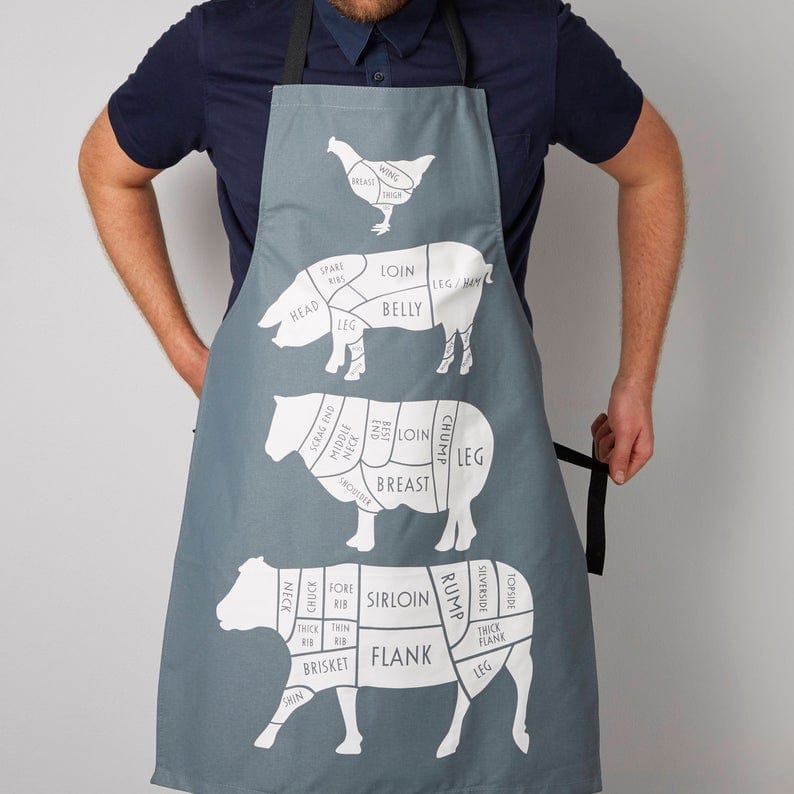 Light grey cooking apron with a chicken, pig, sheep, and cow shown with different cuts of meat shown on them. 