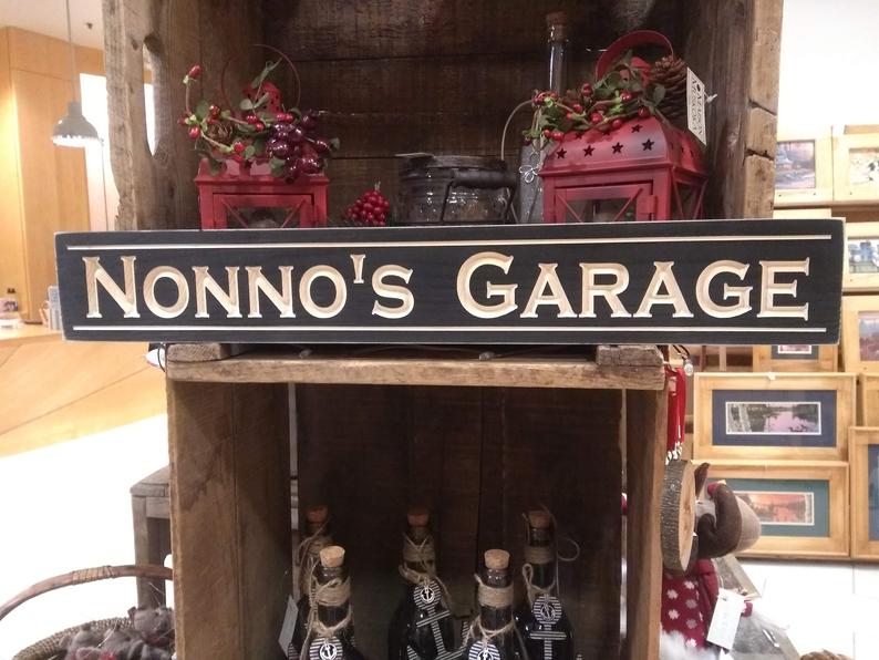 Black rectangle sign that says Nonno's Garage. 