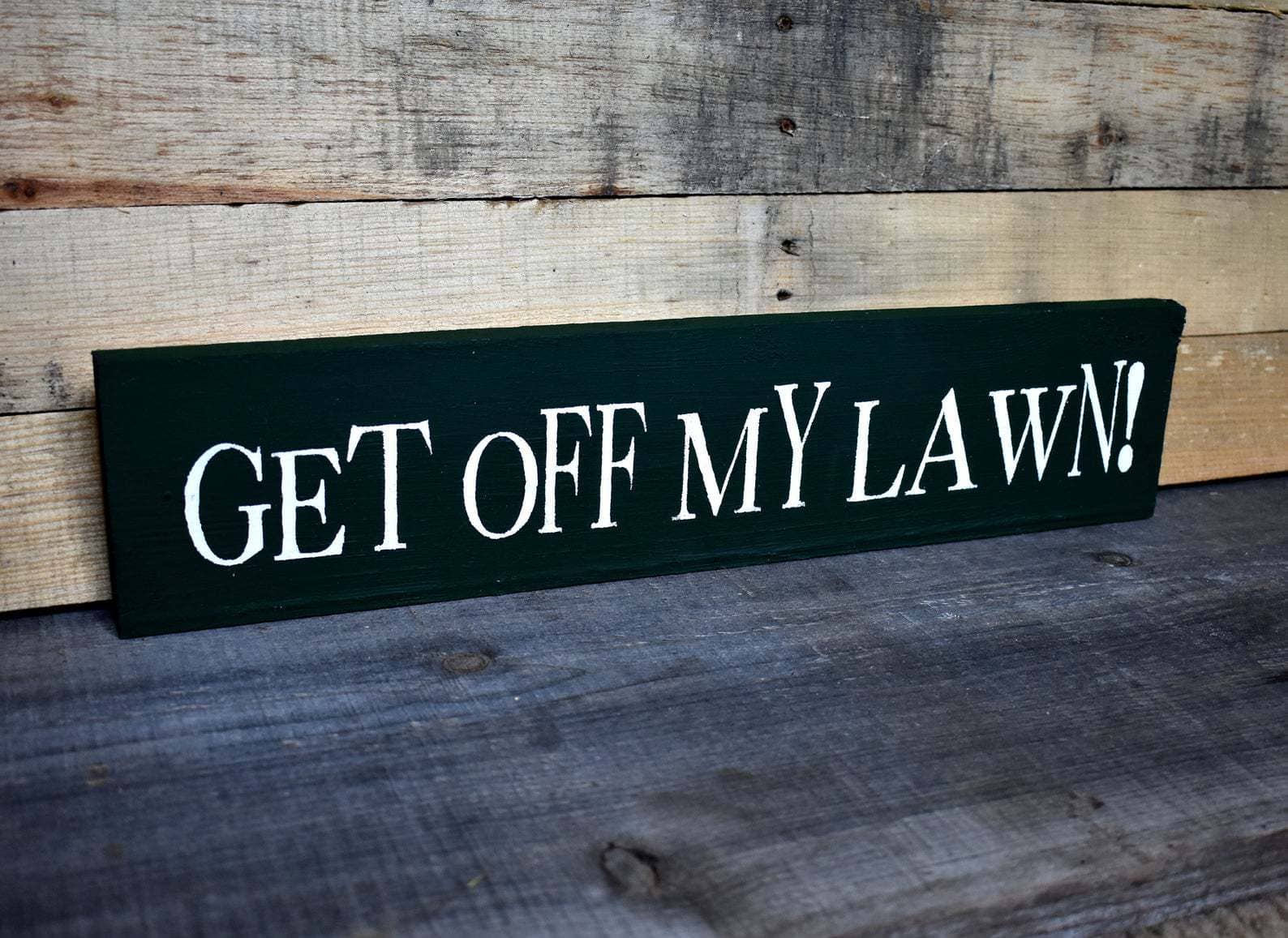 Get Off My Lawn black wooden sign with white font. 