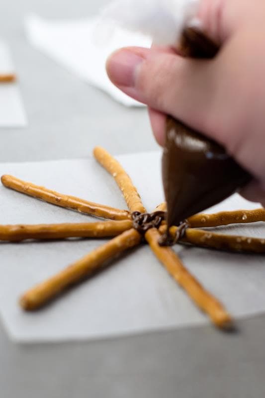 chocolate being spread on pretzels 