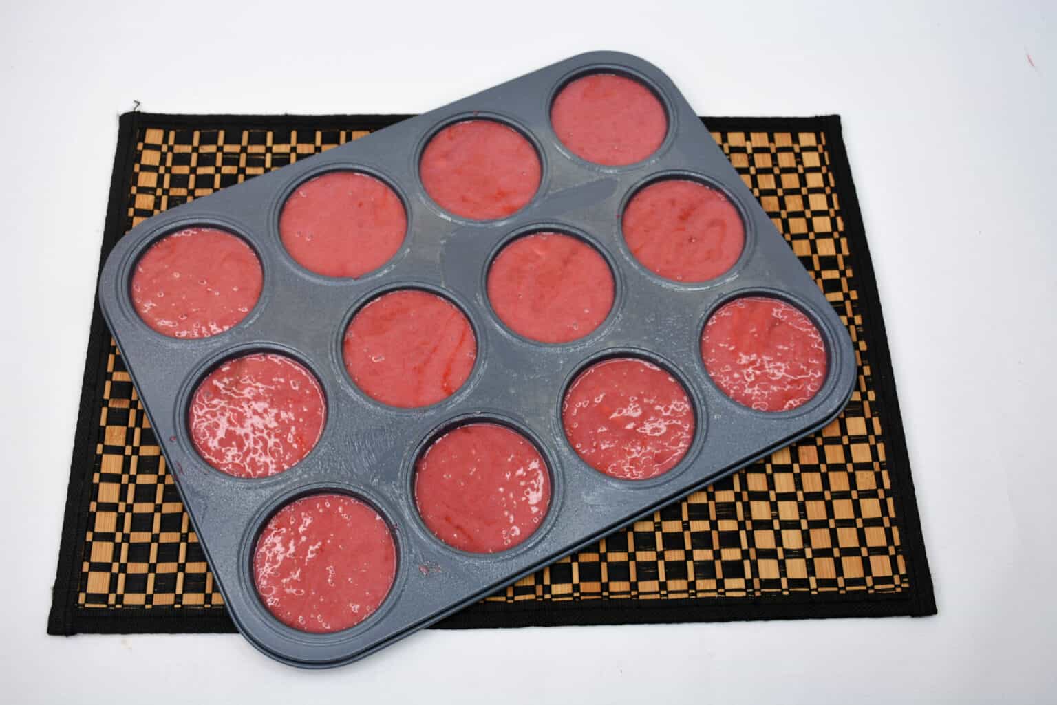 muffin tin filled with raw whoopie pies ready for oven.