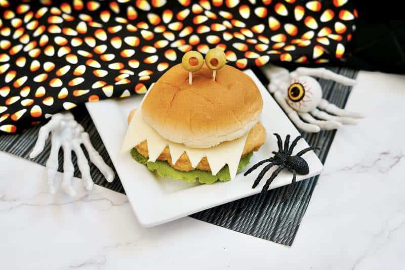 monster chicken sandwiches recipe on a plate with Halloween decorations