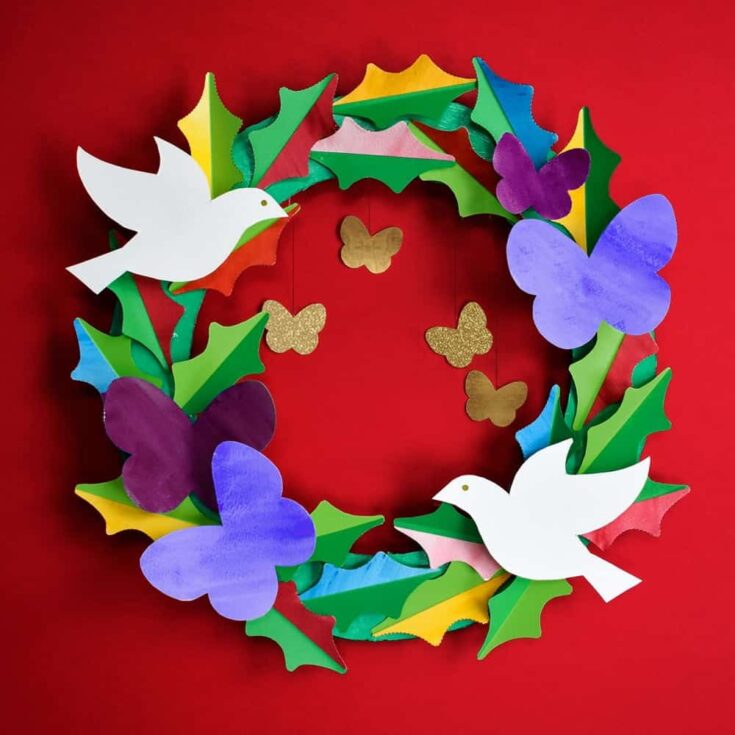 paper wreath with doves, holly, and butterflies