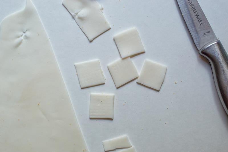pieces of fondant being cut for a Halloween treat