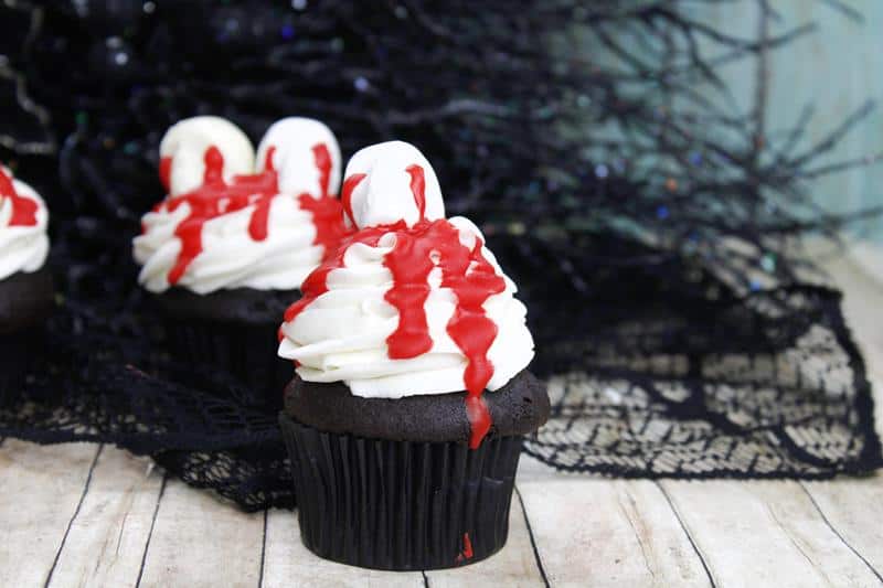 Halloween skull cupcake with bloody skull candy decoration on top