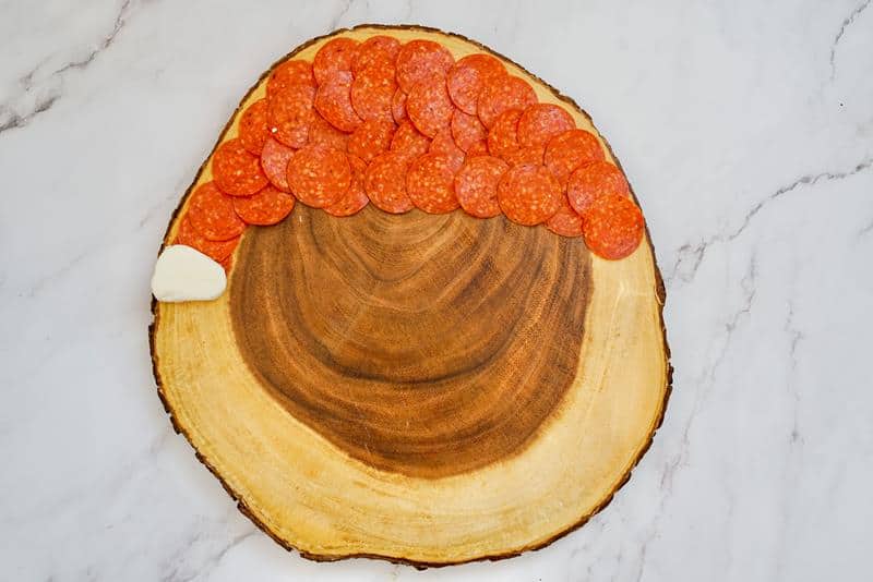 pepperoni and cheese on a wood tray 
