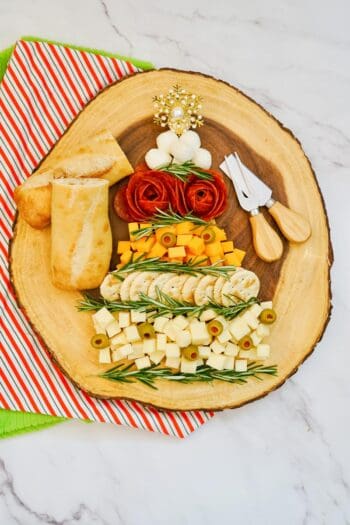 cheese and cracker spread with meat in the shape of a Christmas Tree