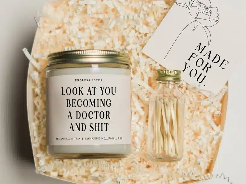 Candle that says "Look at you becoming a doctor"