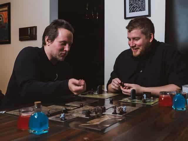 Adults playing a board game