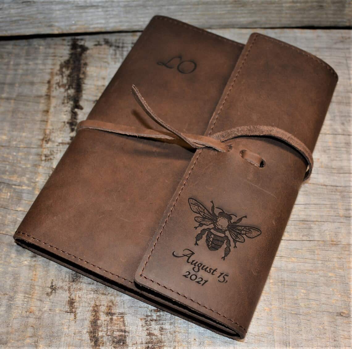 Personalized leather journal with bee on it and the date August 15, 2021 below it. 