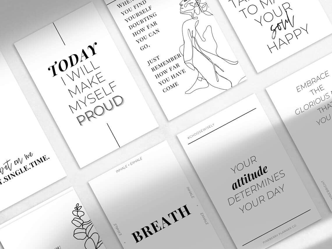 Many different white journal cards with inspirational sayings with black font on them.