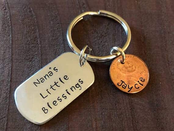 Keychain that says Nana's little blessings and a penny charm beside it with a Childs name on it.