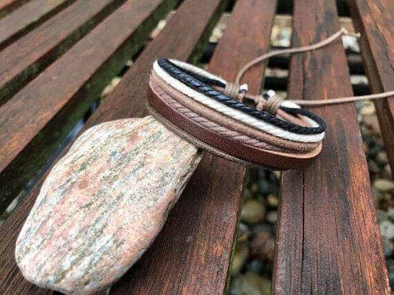 Leather bracelet propped on a rock. 