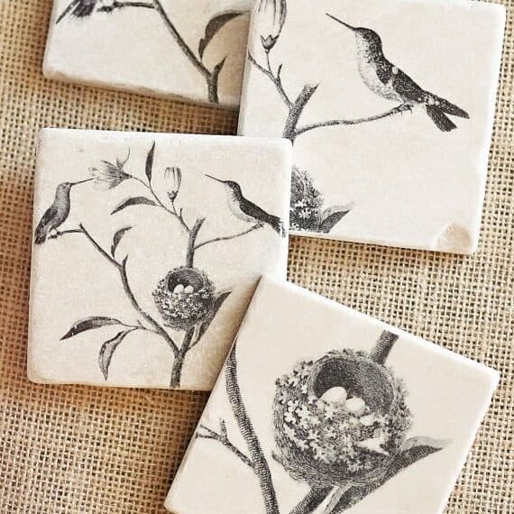 Easter Gifts for Friends: four white square coasters with black print of hummingbirds. 
