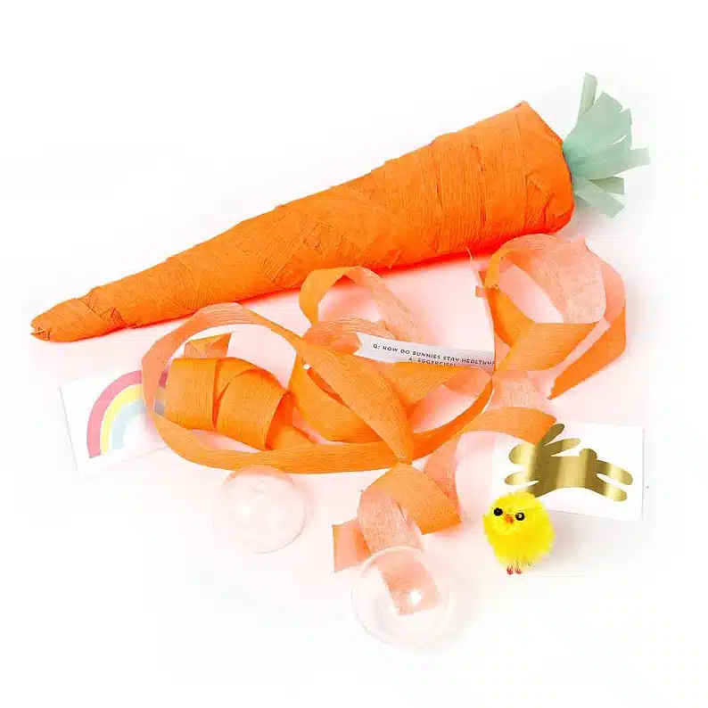 Easter Classroom Gifts for 5th Grade Students: Carrot shaped cracker, one solid and one apart showing little treats inside, bunny sticker, toy chick, temporary tattoo, and a joke. 