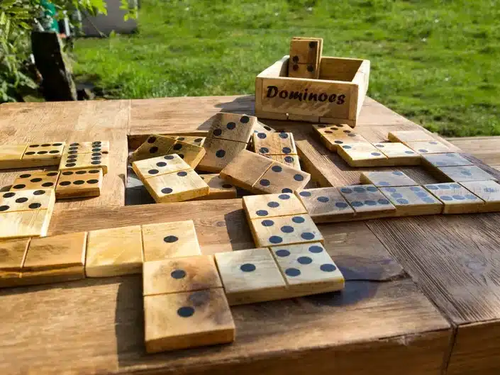 Wooden table with various wooden dominos on it. 