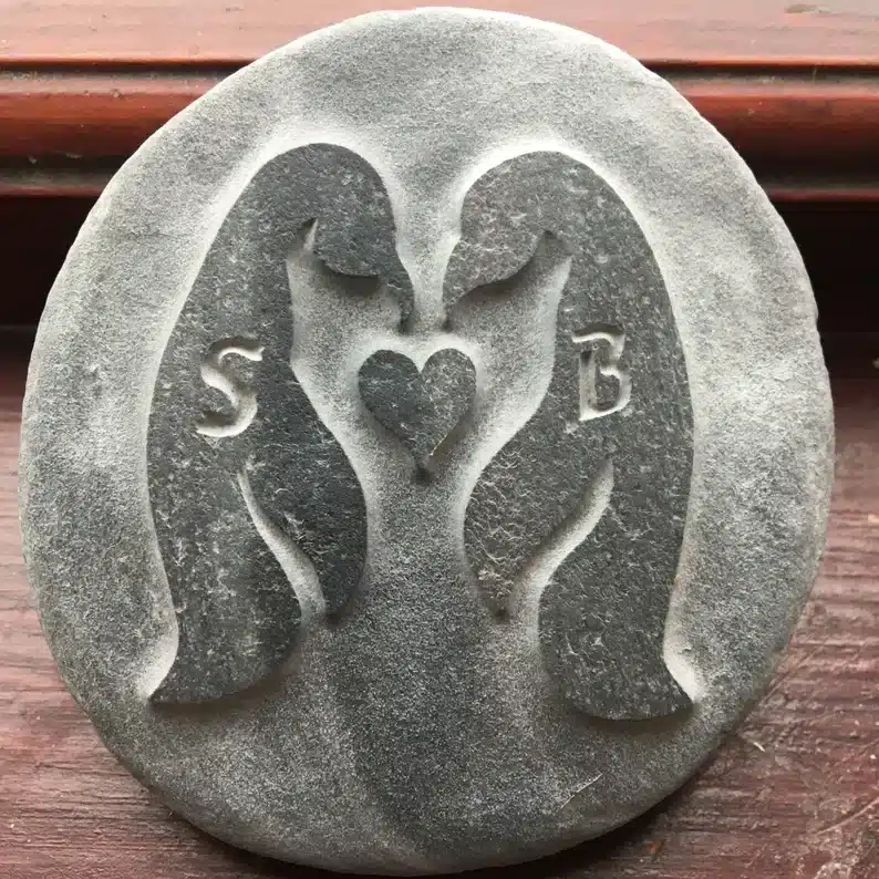 40 Gift Ideas for an Older Woman: Personalized hand-carved stone with two penguins with S and B on each one with a heart between them. 