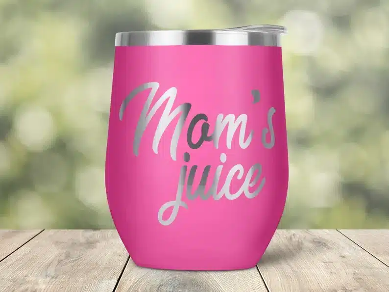 Hot pink stainless steel wine tumbler that says Mom's juice in silver font. 
