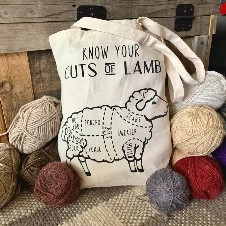 White book bag with black font that says Know you cuts of lamb, with a lamb below. 