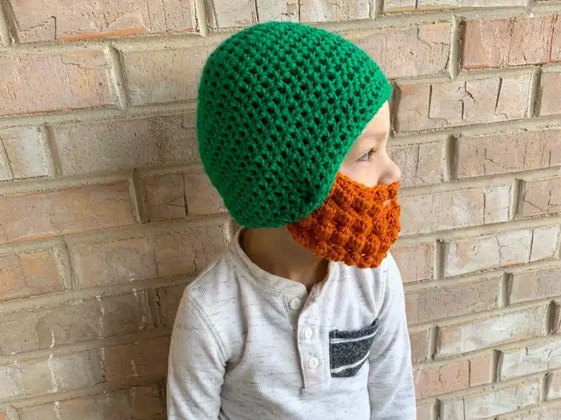 Toddler wearing a leprechaun hat with a beard