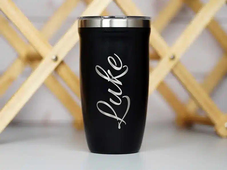 Black travel mug with silver name Luke on it. 