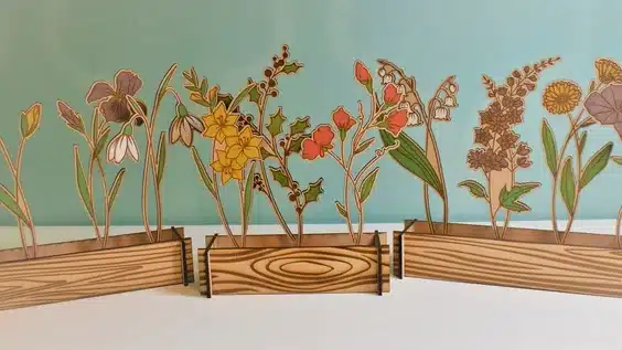 PERSONALIZED FAMILY GARDEN, WOODEN BOXES WITH FLOWERS STIKCING OUT BASED ON FAMILY MMEBERS BIRTHDATES. 