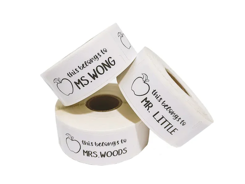 Three white rolls of personalized labels. 