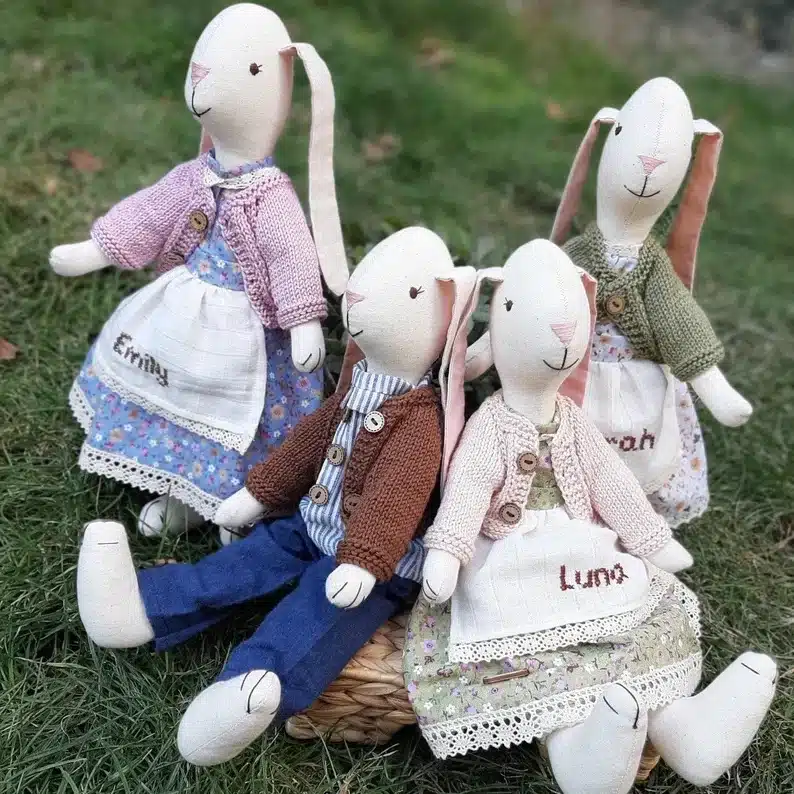 four bunny dolls all with names of family members and outfits on. 